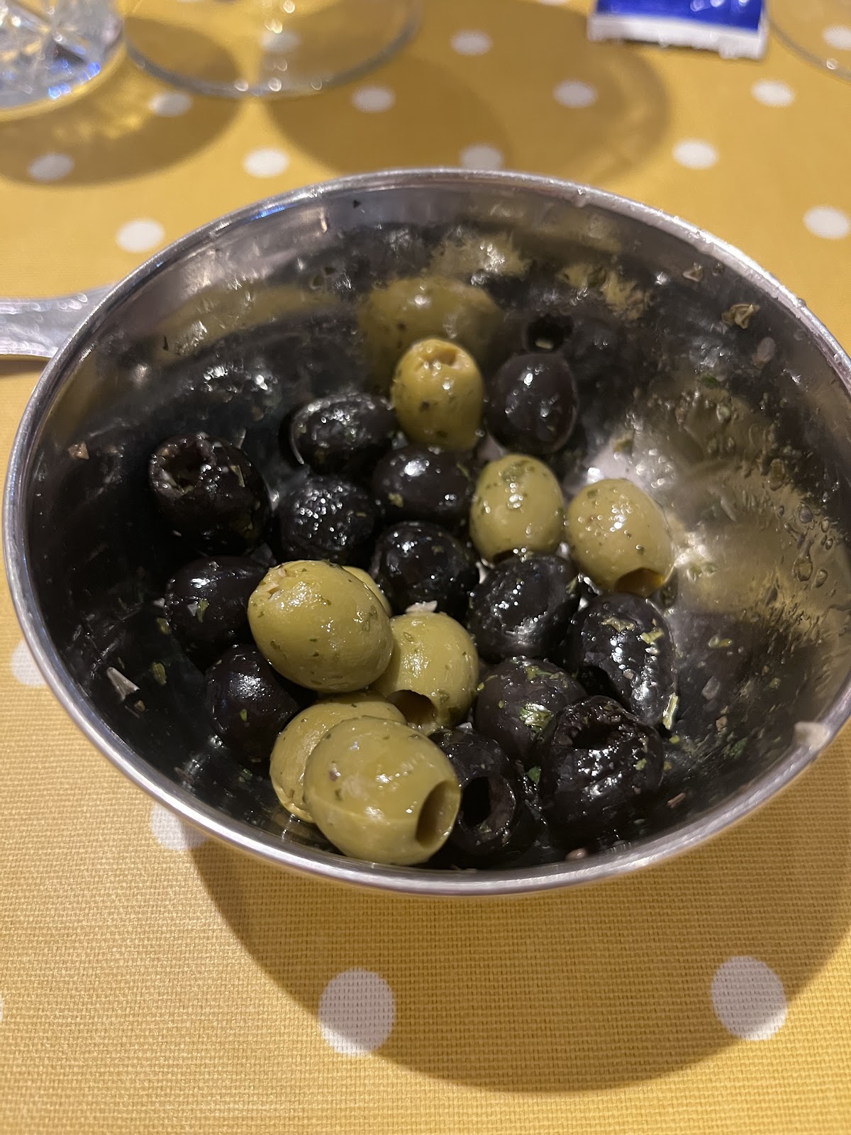 Green and black olives in a metal bowl at Anacapri